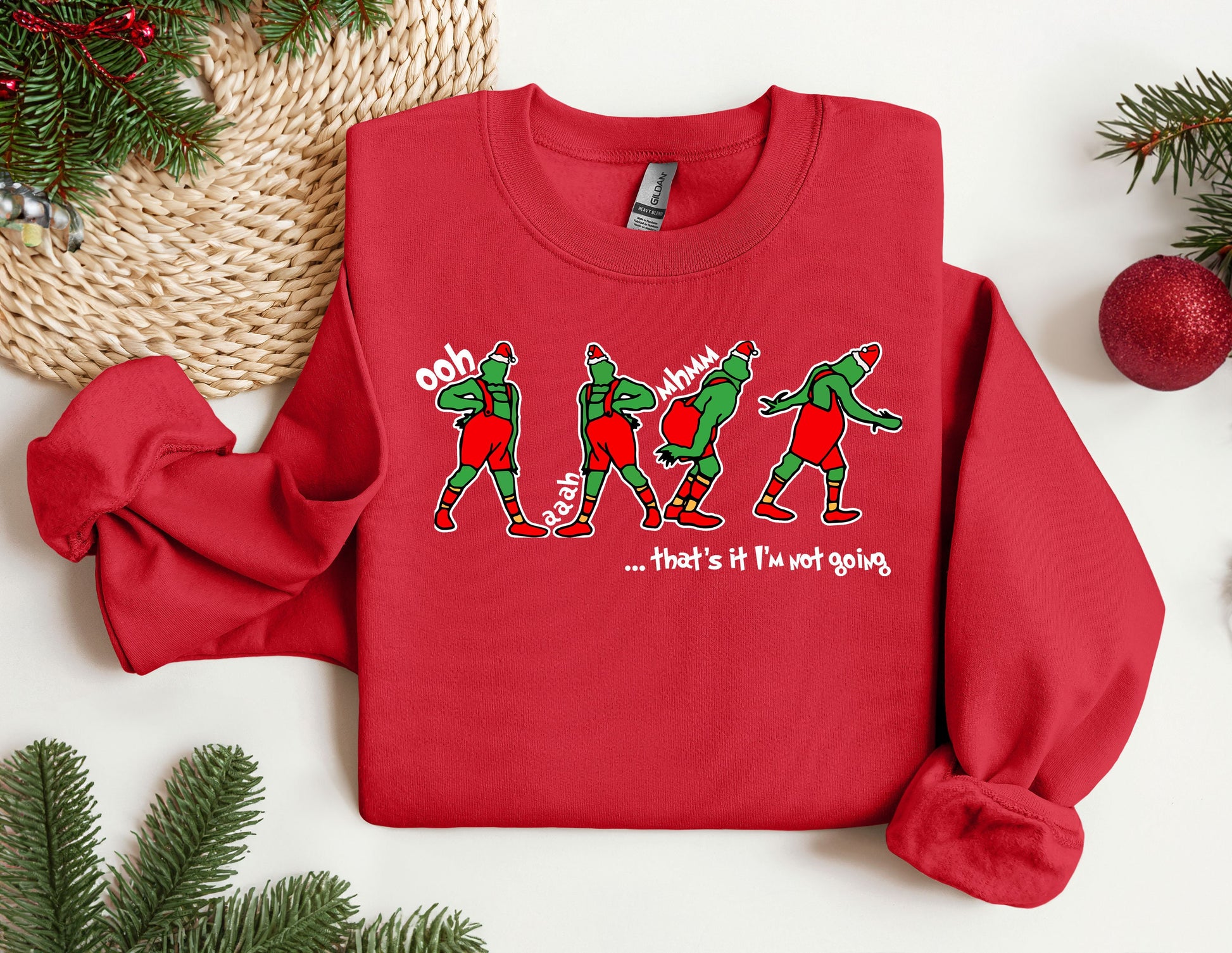 a red sweater with a group of elves on it