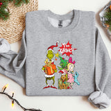 a grey sweatshirt with the grinch on it next to a christmas tree