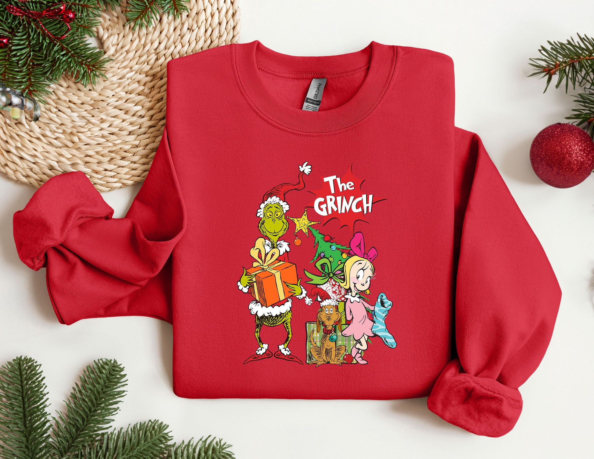 a red sweatshirt with the grinch characters on it