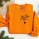 an orange sweater with a message written on it