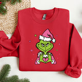 a red sweater with a grin face wearing a santa hat