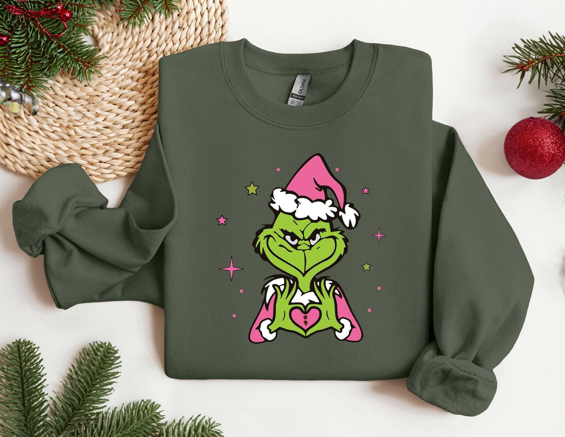 a green shirt with a picture of a grin face wearing a santa hat