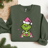 a green shirt with a picture of a grin face wearing a santa hat