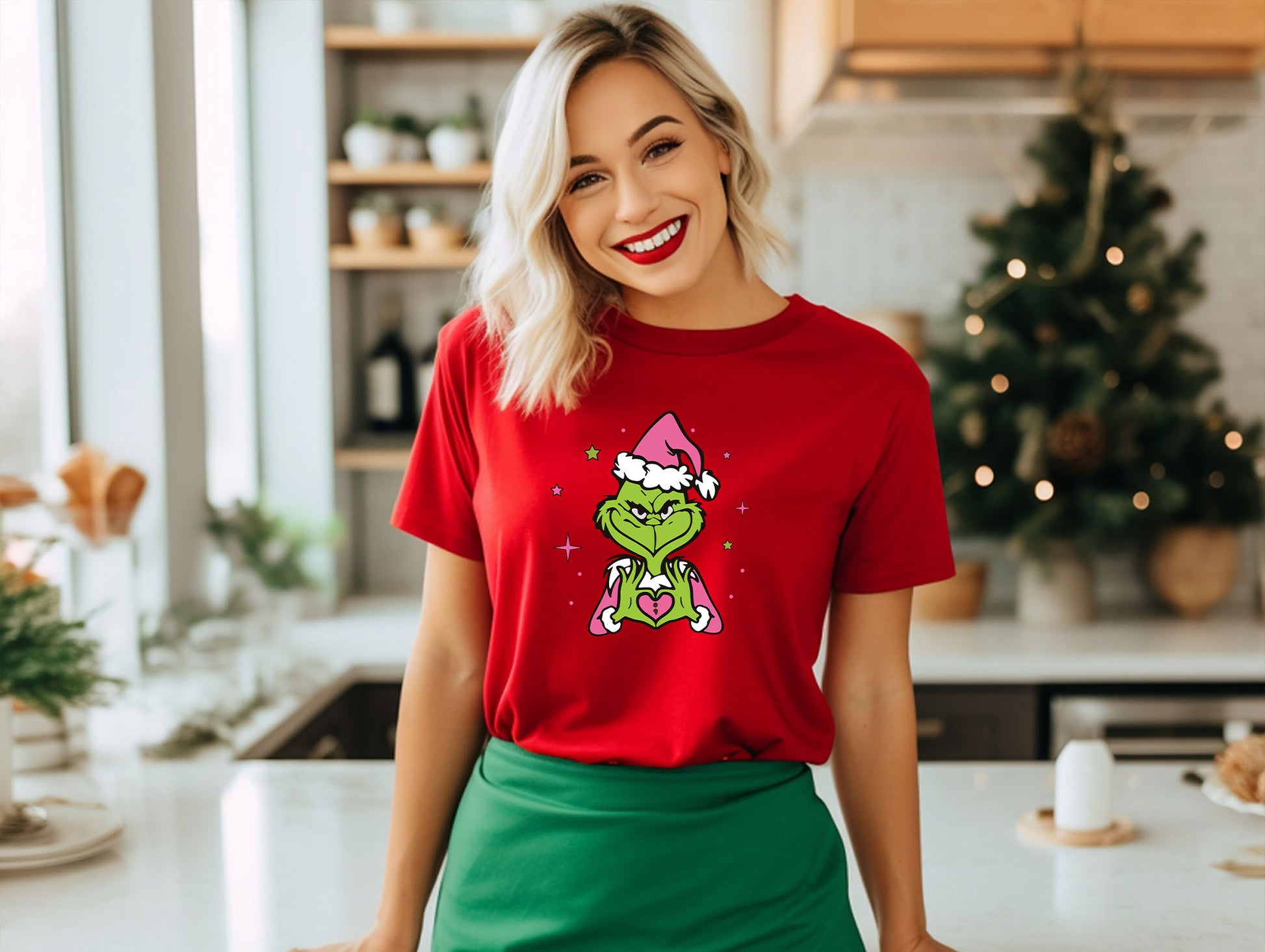 a woman wearing a grin face t - shirt standing in a kitchen