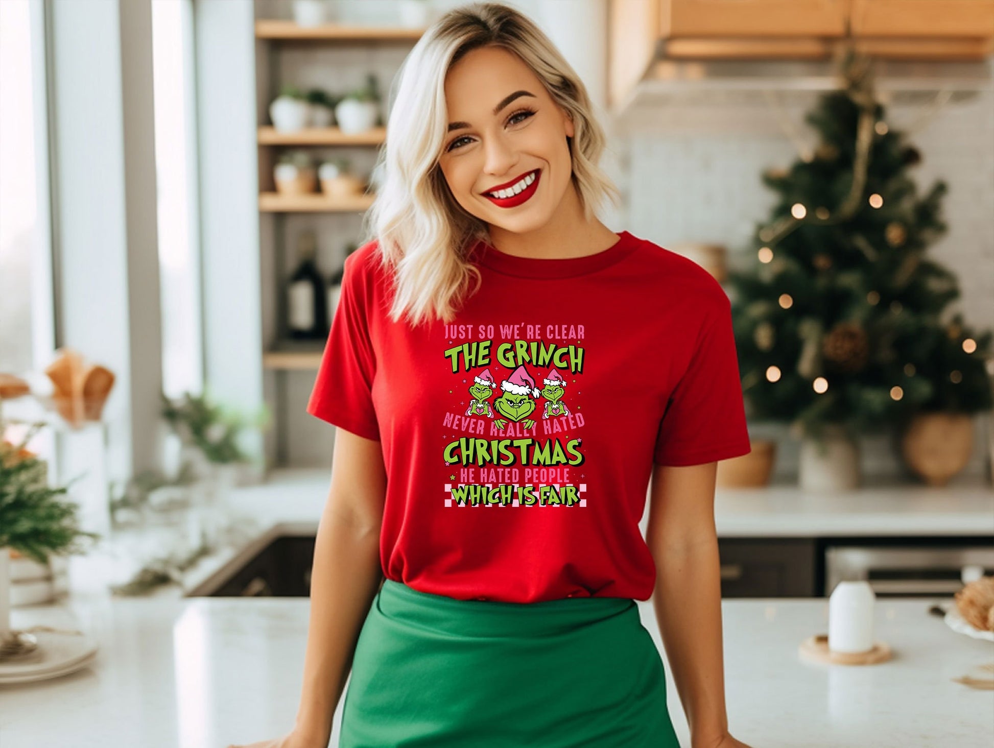 a woman standing in a kitchen wearing a red t - shirt