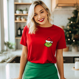 a woman standing in a kitchen with a grin face on a red shirt