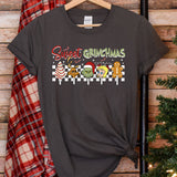 a t - shirt hanging on a wall next to a christmas tree
