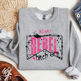a grey sweatshirt with a pink ribbon on it
