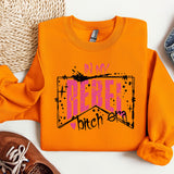 a pair of shoes and an orange shirt on a white surface