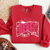 a red sweatshirt with the words in my heart, and a pair of sneakers