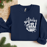 a blue sweatshirt with a rockin'in the 90's design on it