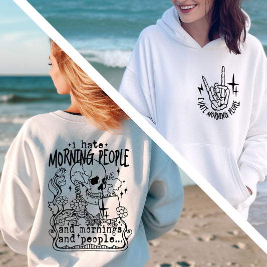 two women wearing matching sweatshirts on the beach