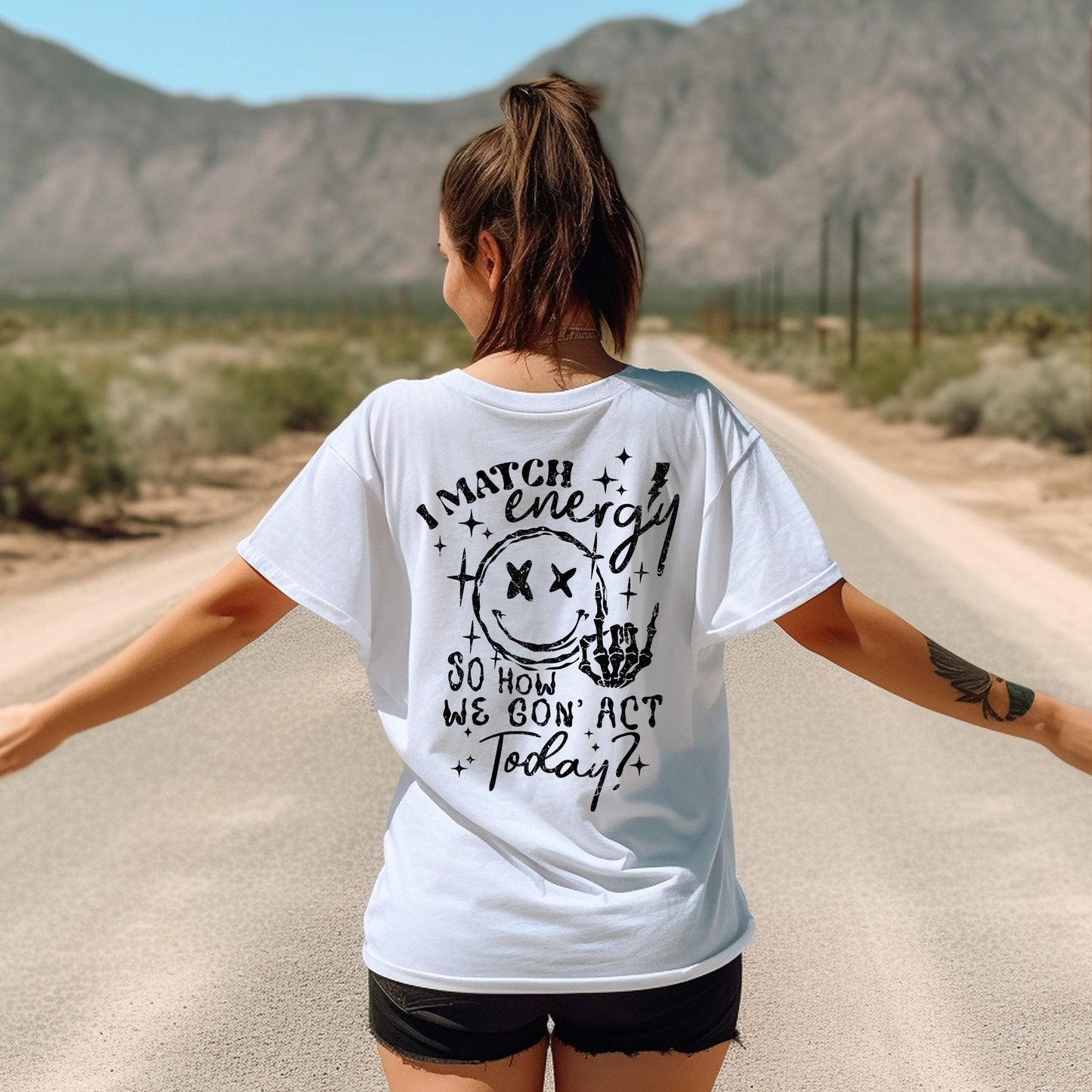 a woman walking down a road with her arms outstretched