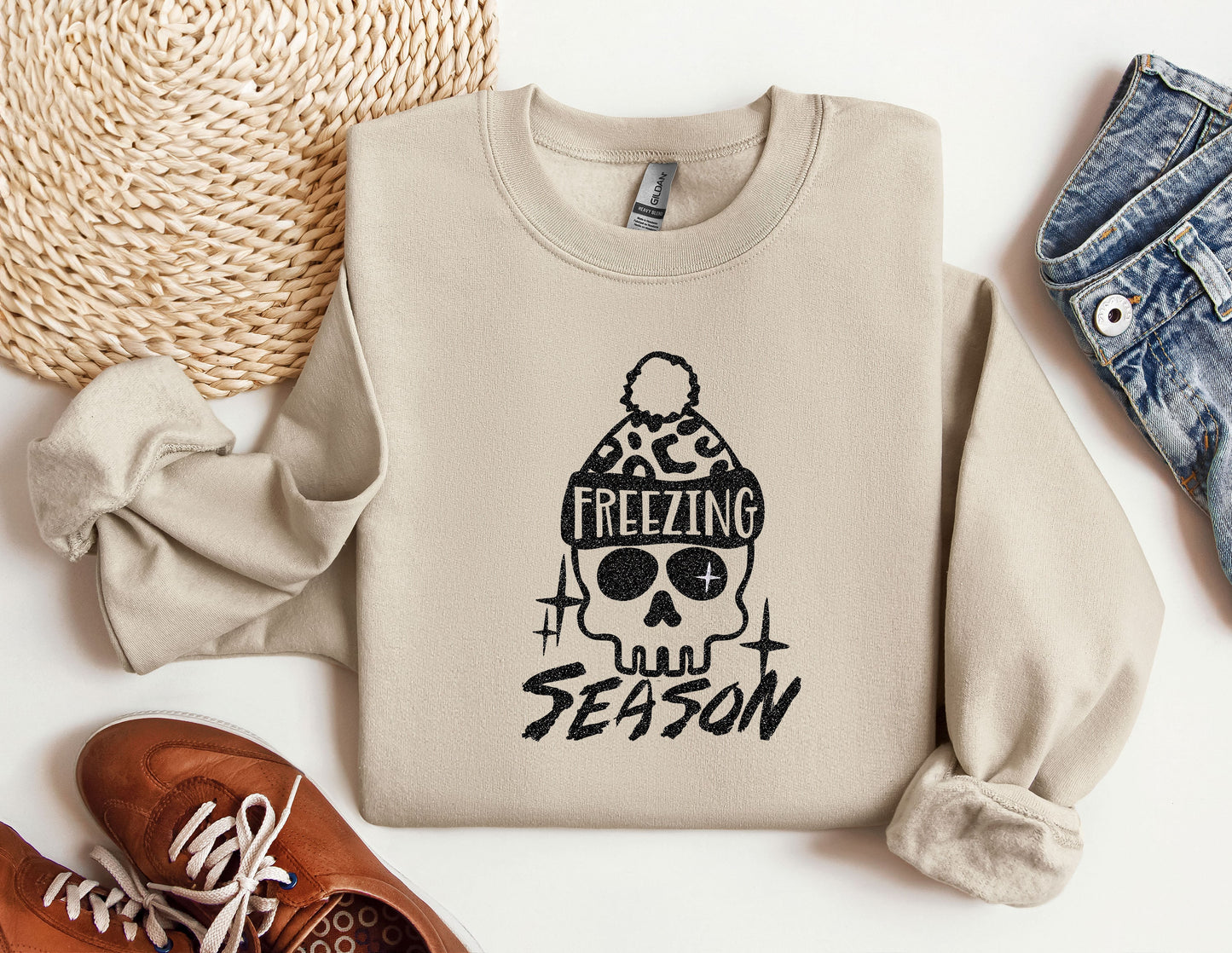 a sweater with a skull on it next to a pair of shoes