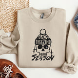 a sweater with a skull on it next to a pair of shoes