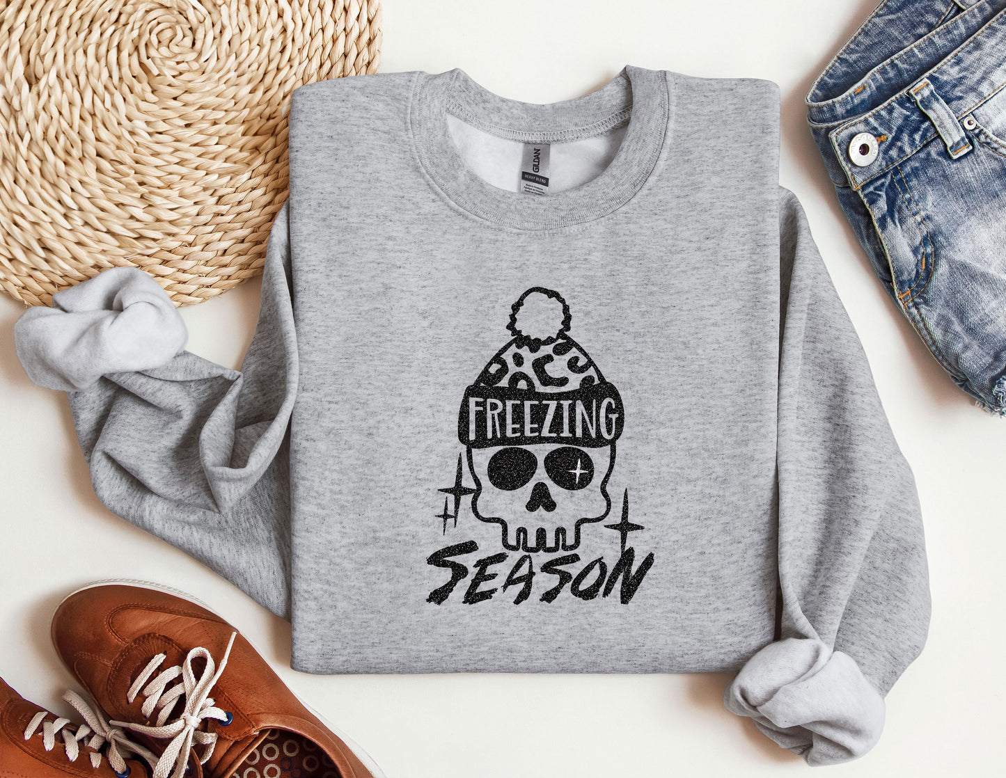 a sweater with a skull and a hat on it