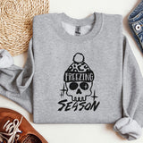 a sweater with a skull and a hat on it