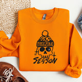 a sweater with a skull on it next to a pair of shoes
