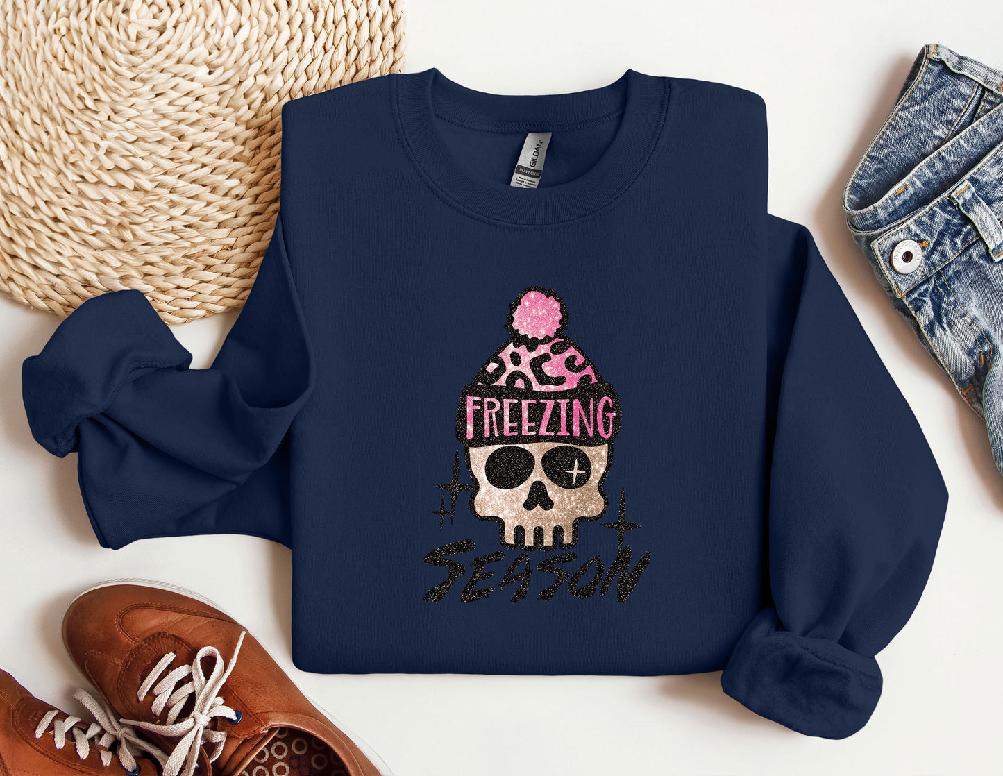 a blue sweatshirt with a skull wearing a pink hat