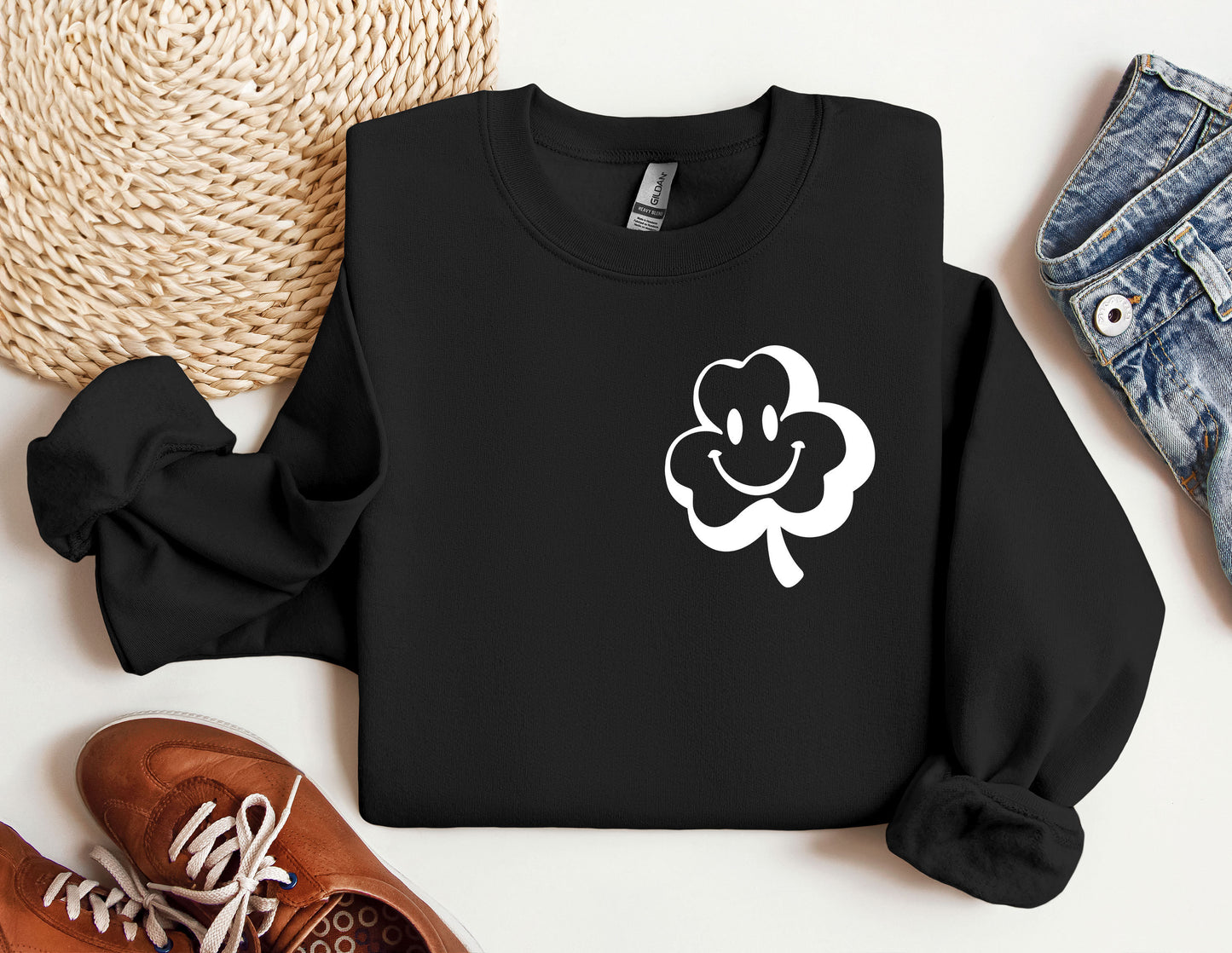 a black sweatshirt with a white clover on it