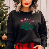 a woman wearing a black sweatshirt with a christmas scene on it