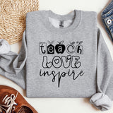 a sweatshirt with the words teach love inspire on it