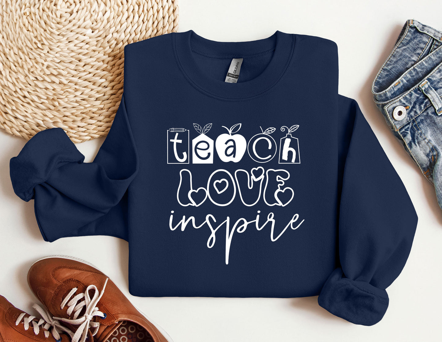 a blue sweatshirt with the words teach love inspire on it