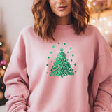 a woman wearing a pink christmas tree sweatshirt