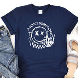 a t - shirt with a picture of a hand holding a camera
