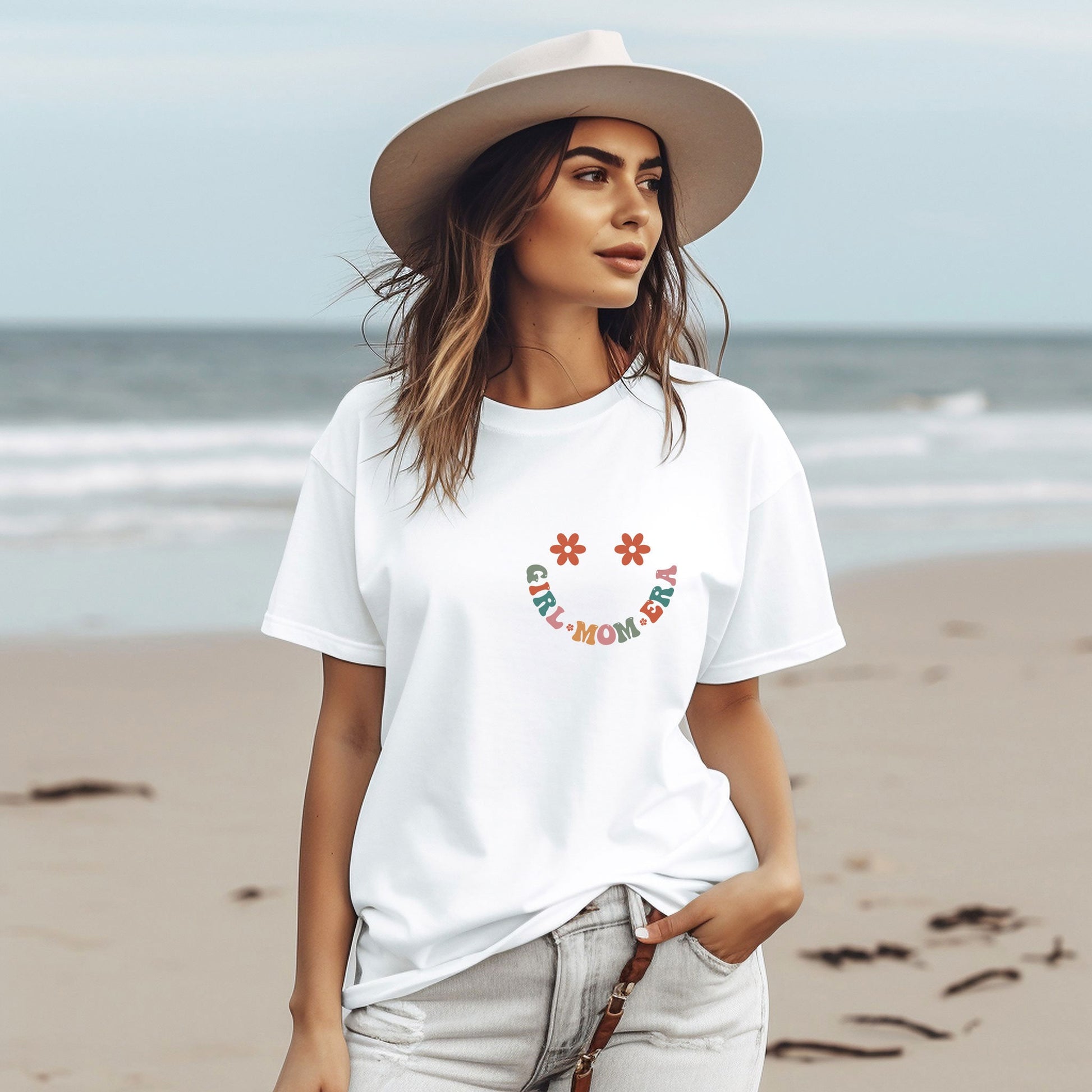 a woman wearing a white t - shirt and hat on the beach