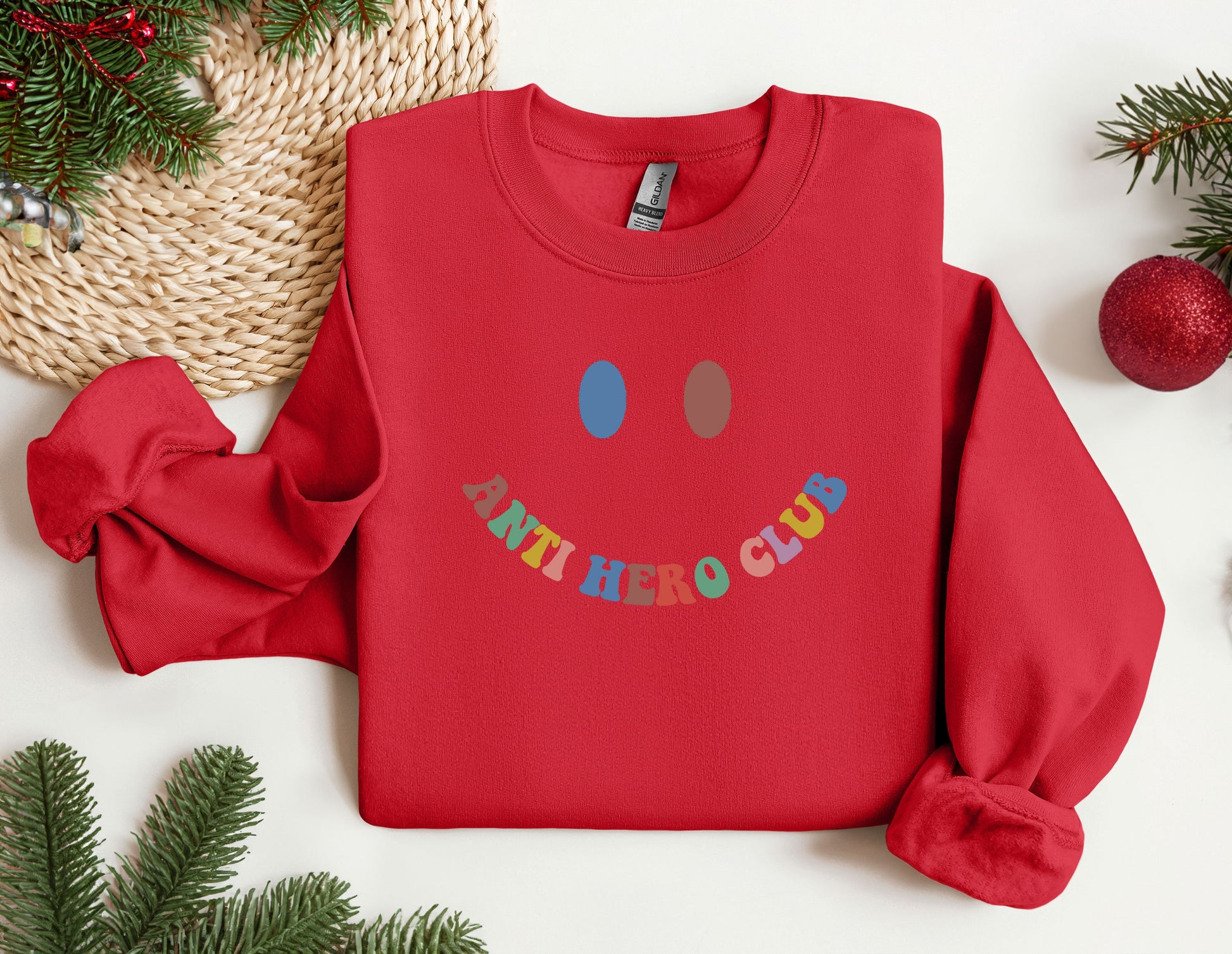 a red sweatshirt with a happy face on it