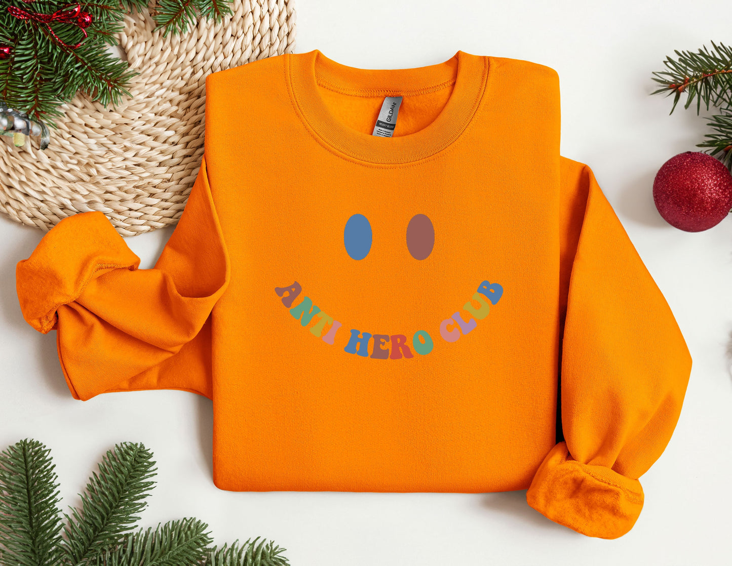 an orange sweatshirt with a smiley face on it