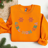 an orange sweatshirt with a smile drawn on it