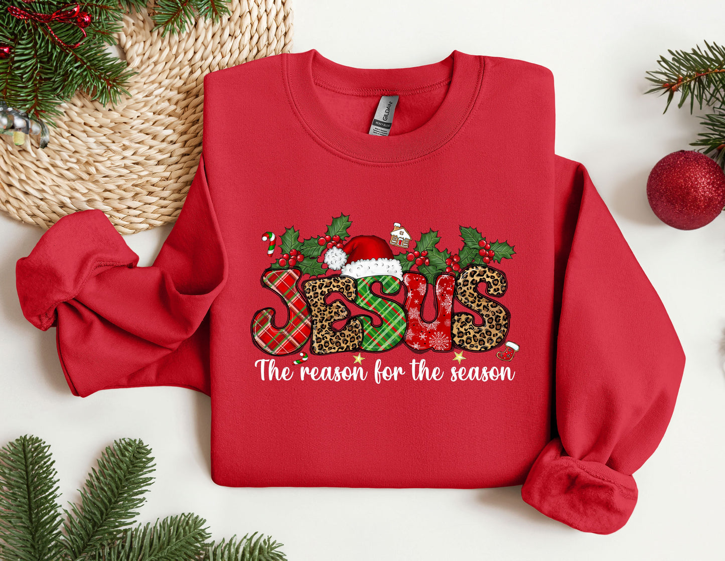 a red sweater with the words the reason for the season on it