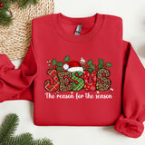 a red sweater with the words the reason for the season on it