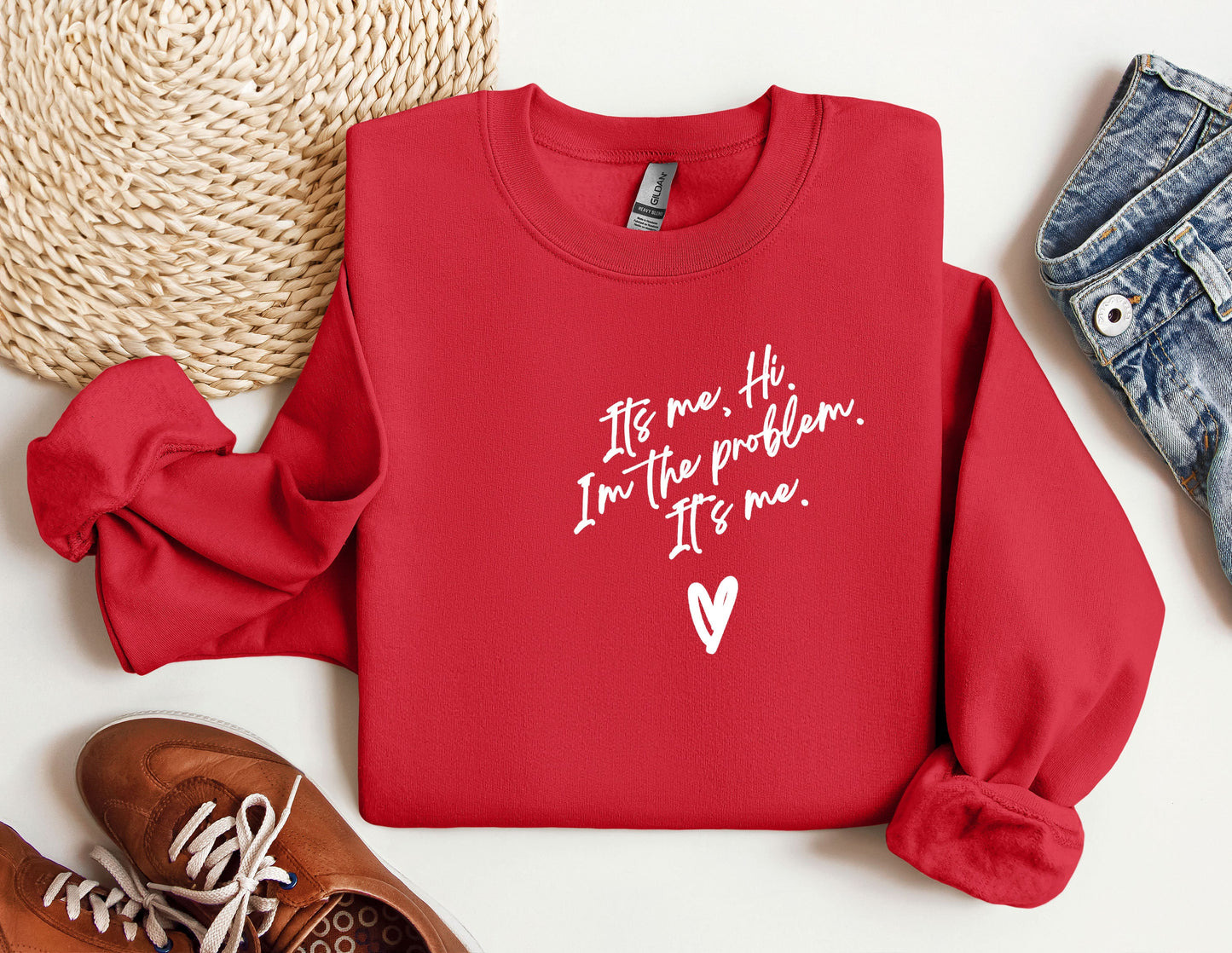 a red sweatshirt with a heart and a pair of sneakers