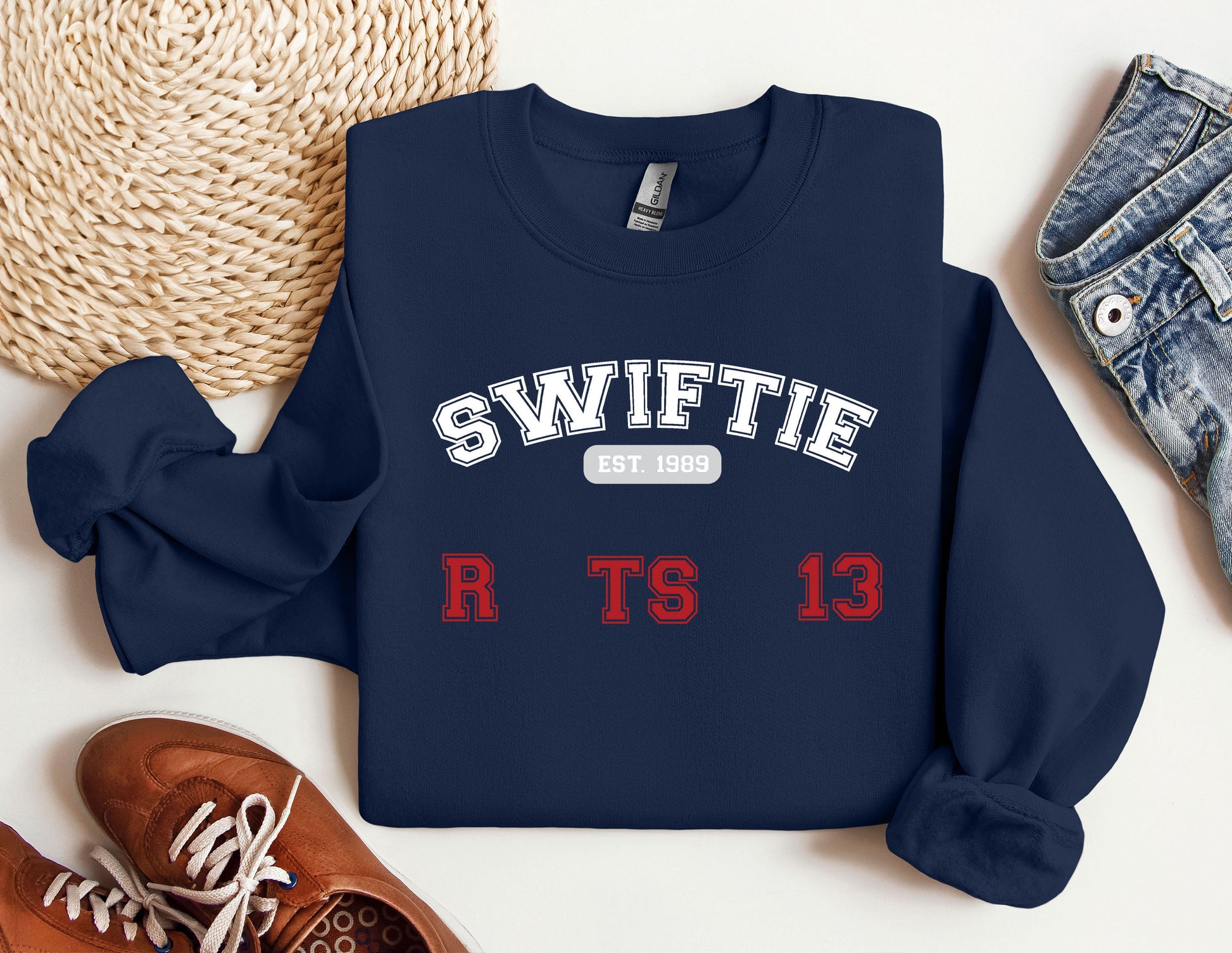 a sweater with the words swiffie on it next to a pair of shoes