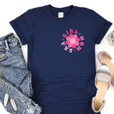 a t - shirt with a flower on it next to a pair of jeans