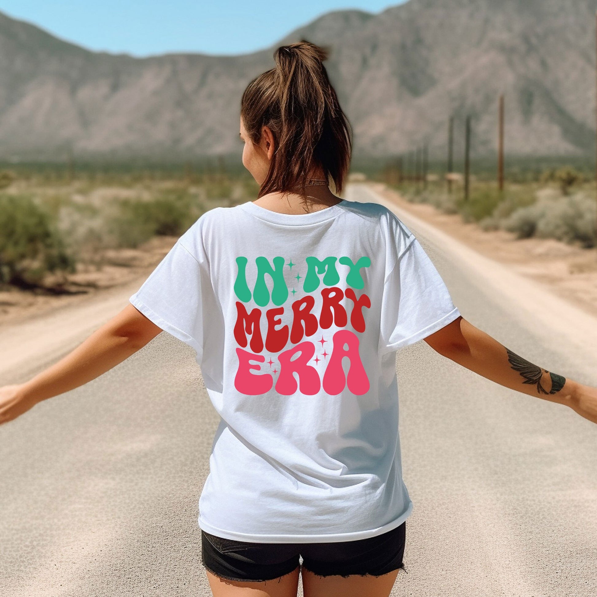 a woman walking down a road with her arms outstretched