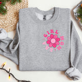 a gray sweater with a pink flower on it