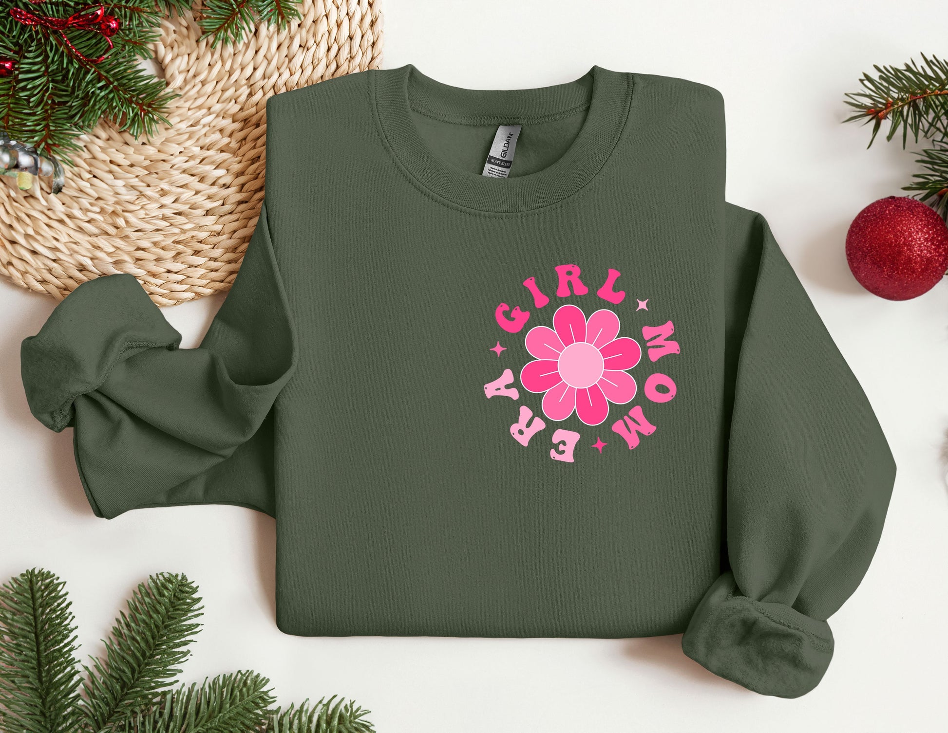 a green sweatshirt with a pink flower on it