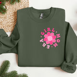 a green sweatshirt with a pink flower on it