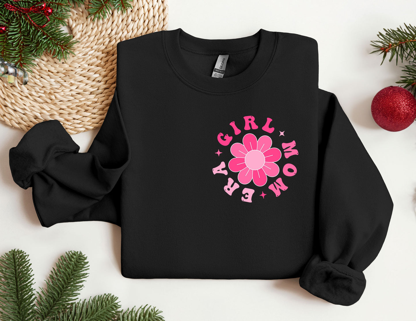 a black sweatshirt with a pink flower on it