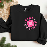 a black sweatshirt with a pink flower on it