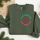 a green sweatshirt with a red and green design on it