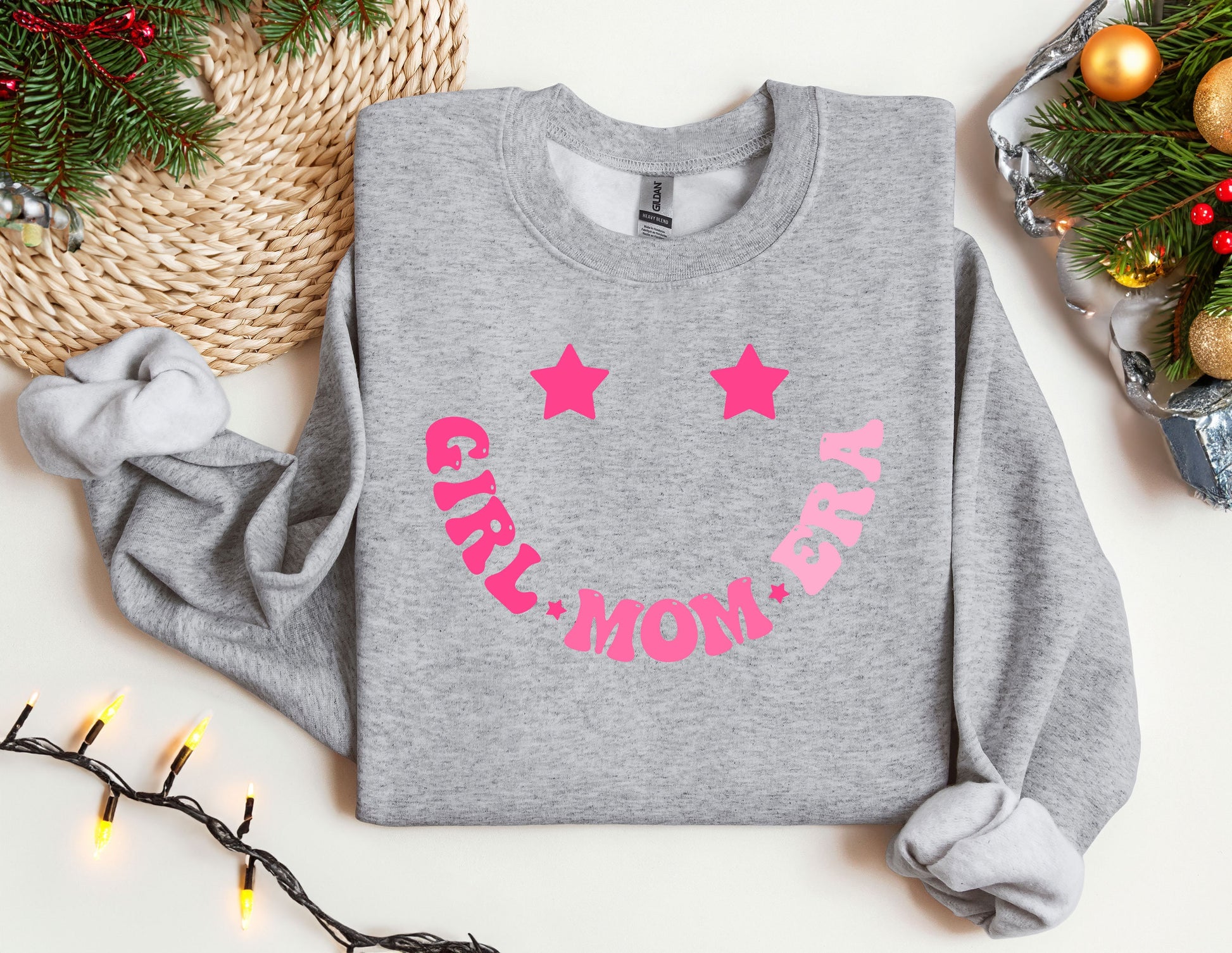 a gray sweatshirt with pink stars and the words stay mom on it