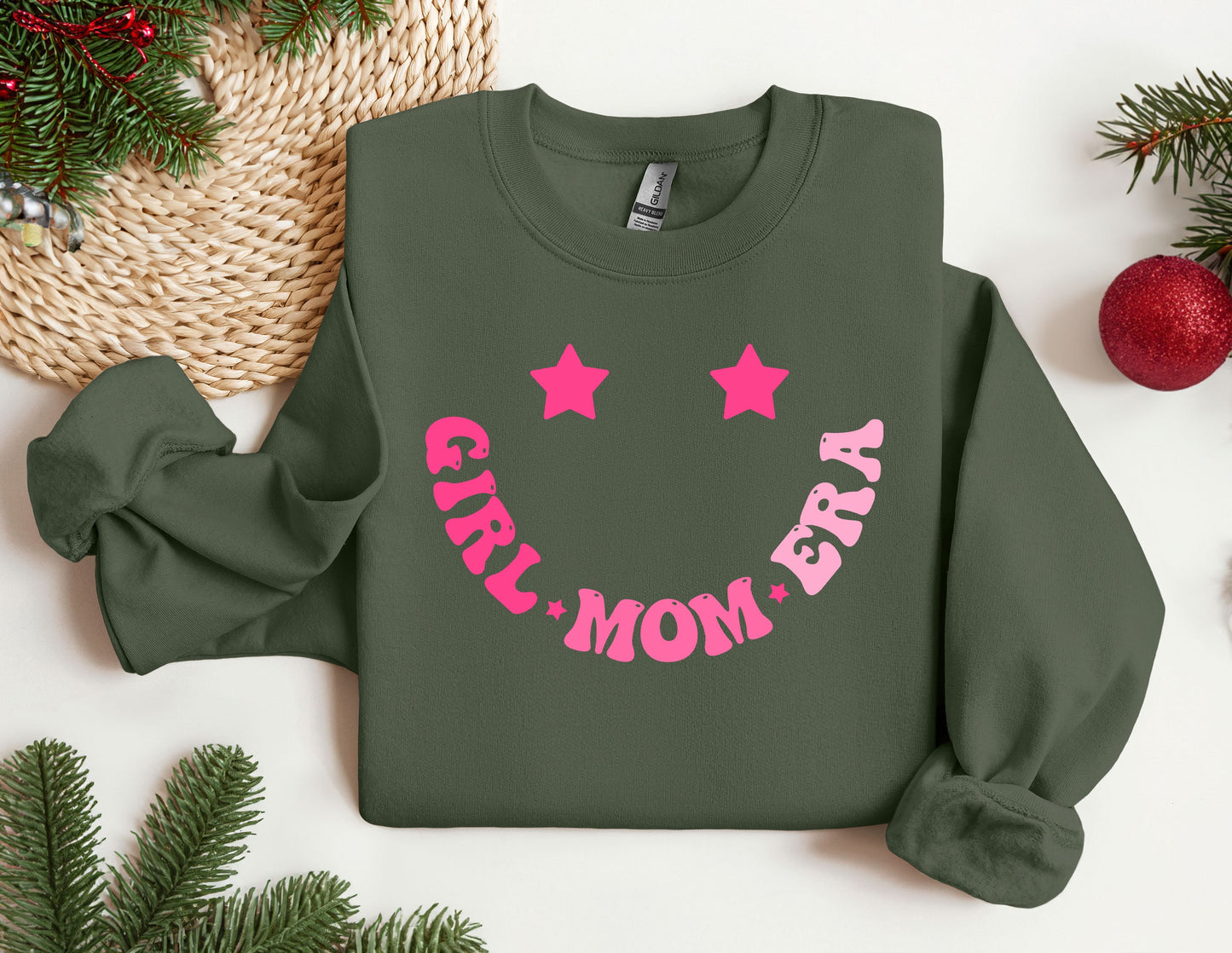 a green sweatshirt with pink lettering and stars on it