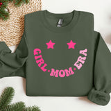 a green sweatshirt with pink lettering and stars on it
