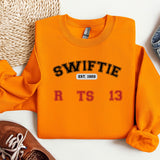 a pair of shoes and a sweater on a white surface
