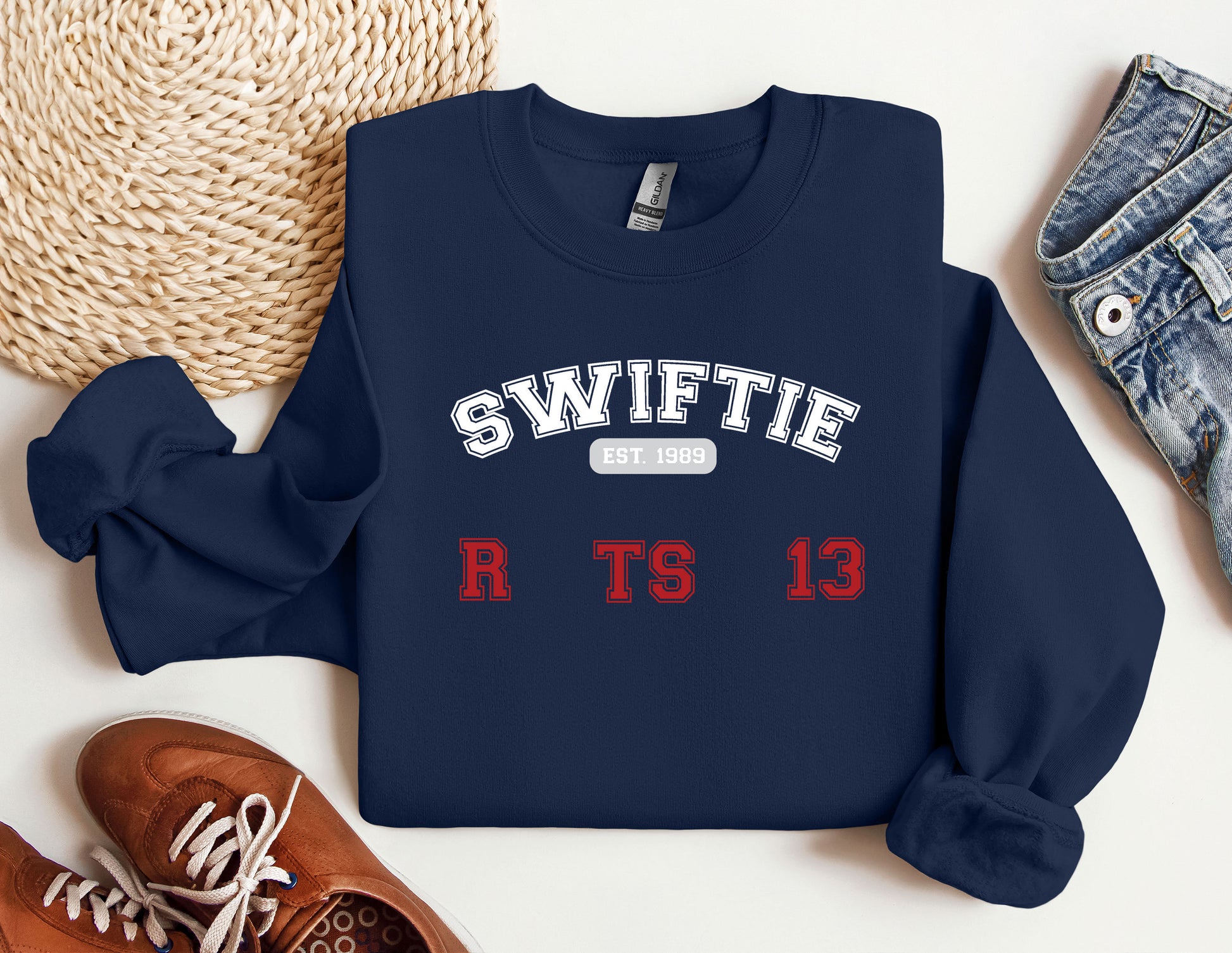 a sweater with the name swiffie on it next to a pair of shoes